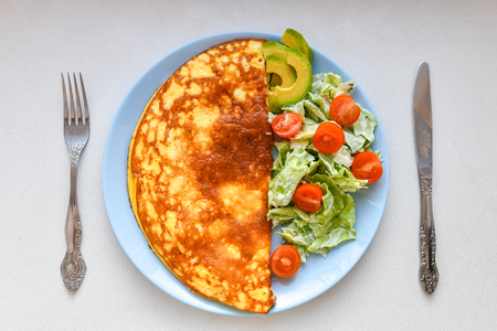 Fried eggs with vegetable salad. Omelet with vegetable salad.の写真素材