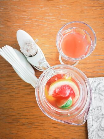 Peach and rosemary lemonade, cocktail on a gray stone concrete table background. Summer drink view from aboveの写真素材