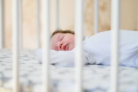 first day of the child at home. Newborn baby sleep first days of life. Cute little newborn child sleeping peacefully.の写真素材