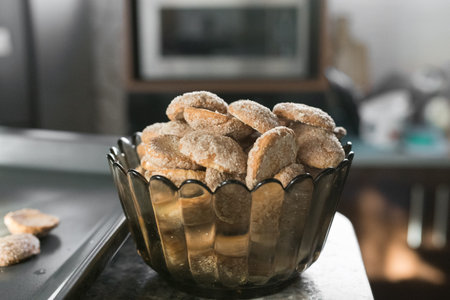 Cookies in a glass bowl. A pile of baked oatmeal cookies in a dark glass bowl.