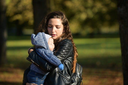 The child shines in the face of the sun. Portrait of a crying girl. The baby is crying. The child...