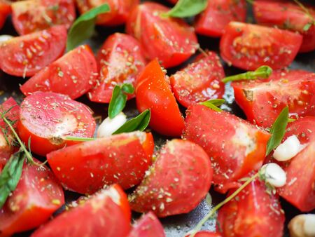 tomatoes with provencal herbs, basil, thyme, and garlic. Vegetarian ratatouille from eggplants, zucchini, tomatoes and bell pepper sauce and tomato with herbs in ceramic form before baking. Top view. Close upの写真素材
