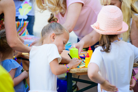 MOSCOW, RUSSIA - April 24, 2019: children and adults at the table do needlework and paint on the...