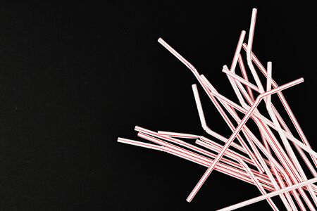 plastic tubules on a black background. randomly scattered. place for an inscription. view from above.の写真素材