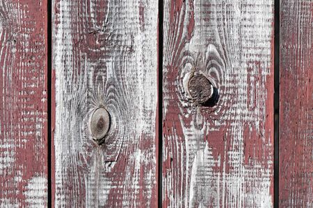 red-gray wooden background. vertical boards. old paint peels off. old boards. Red gray wood texture of a worn painted board. Red gray wood texture of old worn painted board.の写真素材