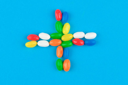 multi colored candies on a blue background. Tasty colorful candies on blue background. Flat lay