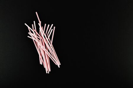 plastic tubules on a black background. randomly scattered. place for an inscription. view from above.の写真素材