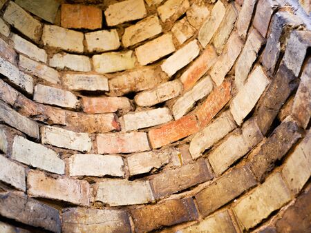 round old brick wall. Inside view of an old brick industrial pipe. close-up.の写真素材