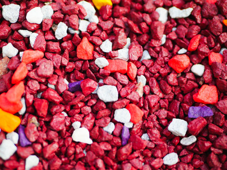 red little pebbles. The background consists of small red pebbles. With many possible uses. The texture is composed of tiny red pebblesの写真素材