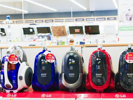 MOSCOW, RUSSIA - April 24, 2019: row of vacuum cleaners on a store counter. stand on a store shelf. A variety of vacuum cleaners are arranged in a row at a home appliance store. Selective focus.のeditorial素材