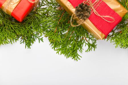 Gift wrapping made of paper on a white background. green branches. place for writing. View from above. Handmade simple christmas gift blank top view background. Gift box, christmas tree.の写真素材