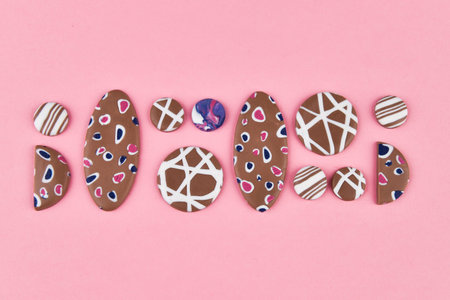 A product from polymer clay. Hand sculpting, product for earrings on a pink background. View from...