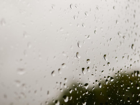 raindrops on the glass. Rainy weather. against the background of a blurred background of nature....