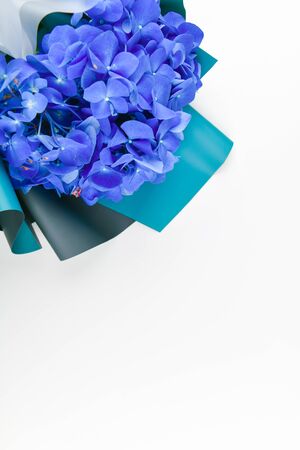 Blue bouquet on a white background. bouquet of iris flowers. The flowers are saturated blue. view from above. Place for writingの写真素材