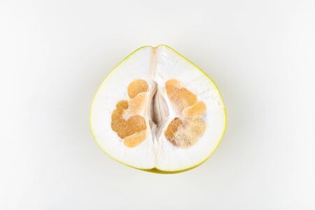 cut pomelo on a white background. Unripe. Small inside. Place for an inscription. Easy cut. View from above. close-upの写真素材
