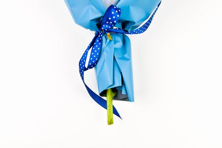 Gift wrapping for flowers. Bottom part. Place for an inscription. Easy to cut. View from above. close-up. Hand holds a bouquet of flowers. Floristry conceptの写真素材