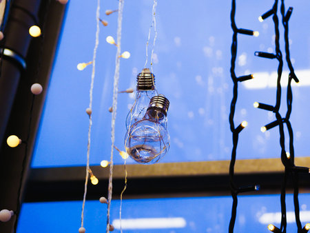 Garlands are hanging on the window. multi-colored light bulbs garlands on a window close-up. New...