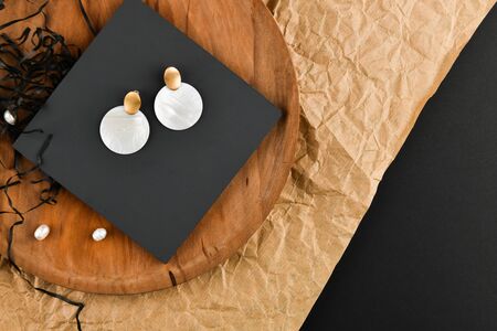Round white earrings. Close-up. Golden latch. Laid out on a wooden stand. View from above. The concept of jewelry and jewelry. Gifts for women. shopping.の写真素材