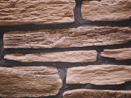 uneven stone facade close-up. Torn stone texture. Stone wall. Stonewall abstract background.