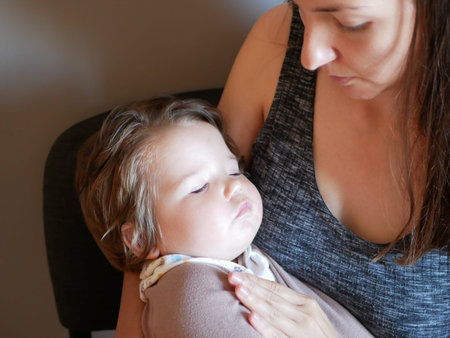The baby sleeps in his mothers arms. Newborn sleeps with mom. Maternal care.