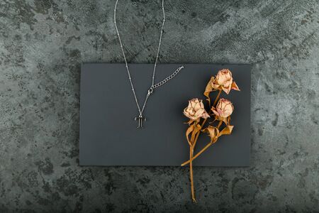 Silver chain on a dark background. decorated with dried roses. handworkの写真素材