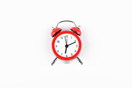 Red retro alarm clock on a white background. Round red alarm clock on a white background isolated. standard timer concept, warning of a change in time, retro signal of the beginning of the work of the clock of the end of the signal.の写真素材