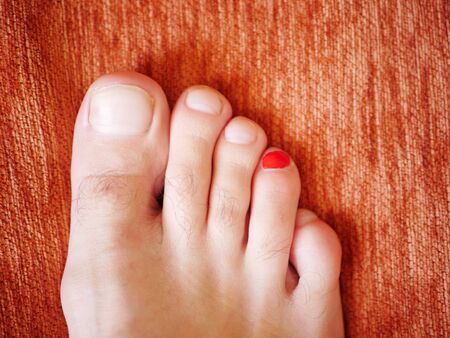 Painted nail on the male foot. in red. view from aboveの写真素材
