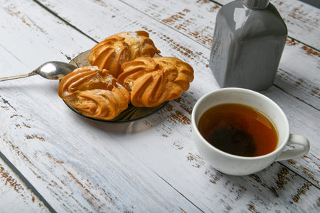 cup of coffee and creamy dough. Cup of coffee and pastry composition. Cup of coffee and sweet pastry...