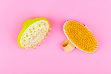 Anti-cellulite massage brushes. top view. Massage brush. On a pink background. Accessories for massageの写真素材