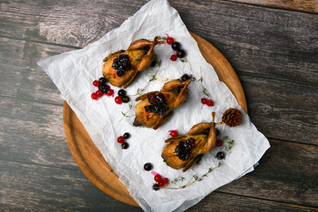 quail on a wooden background. On a wooden background. Little turkey. Close-up. Three quails. Small bird. Chicken replacementの写真素材