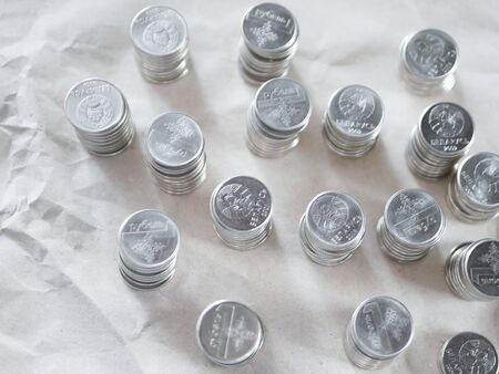 Silver coins close up. Counting savings. Tax rate. Production costs. Distribution of finance. Laid out by a column.の写真素材