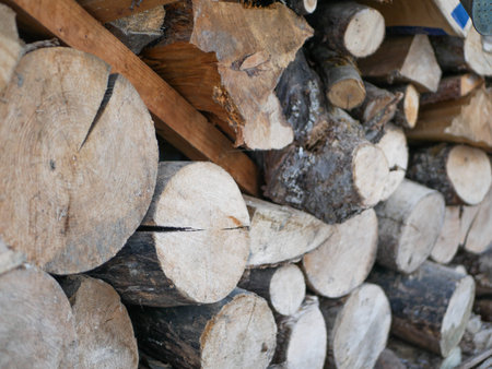 Stocks of firewood for the winter. logging for the winter. Wooden background. Firewood for the...