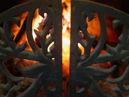 Fireplace grate close up. in a low key. Cast iron fireplace grateの写真素材