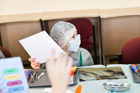 Masked children study medicine. Training class in dentistry. children and a dentist. Teaching...