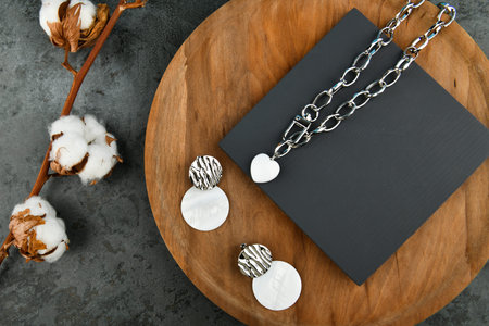 Set of silver jewelry with earrings. Heart-shaped pendant on a silver chain. Decorations for...