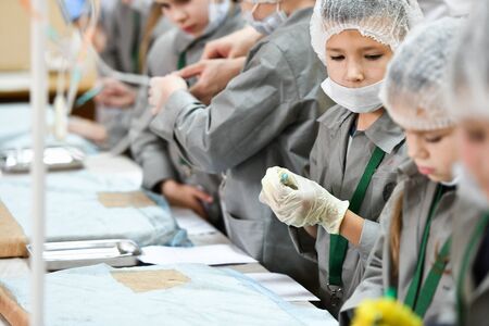 A group children medical training. A group of children are studying surgery. Teaching medicine. Young doctors at a seminar in a hospital. KHARKOV, UKRAINE - JANUARY 20, 2020.のeditorial素材