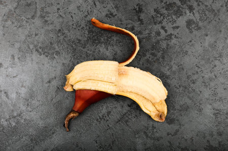 Red bananas on a dark background. Red bananas are shorter, a kind of banana. Brown banana variety