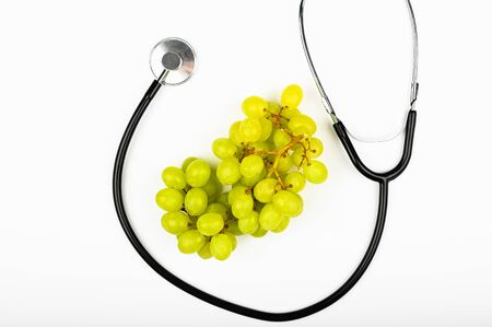 green grapes and health. on white background. view from above. A place to write. A bunch of green grapes. The concept of the usefulness of grapesの写真素材