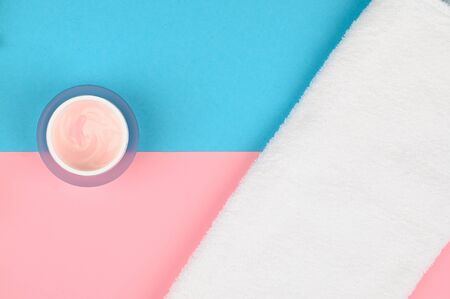 white towel and cream. on a pink-blue background. open and closed buds, place for an inscription. flat layの写真素材