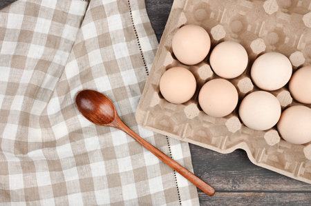 A tray with eggs on a wooden table. View from above. eco tray with eggs on a wooden table,...