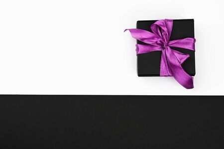 Gift wrapping by bow on a black and white background.の写真素材