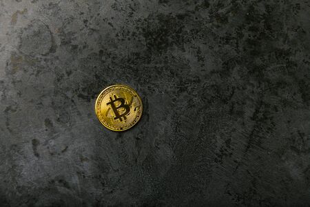 bitcoin on dark marble. place for an inscription. gold coin bitcoin against the background of a dark stone.の写真素材