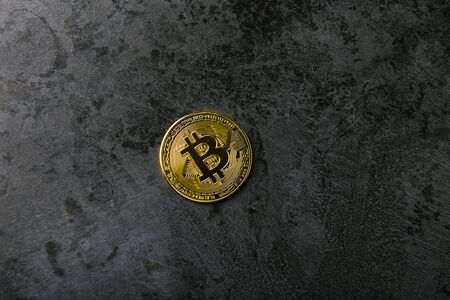 bitcoin on dark marble. place for an inscription. gold coin bitcoin against the background of a dark stone.の写真素材