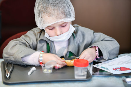 The child is studying dentistry. Training class in dentistry. children and a dentist. Teaching Dentistry. Training at the dentist. KHARKOV, UKRAINE - JANUARY 20, 2020.のeditorial素材