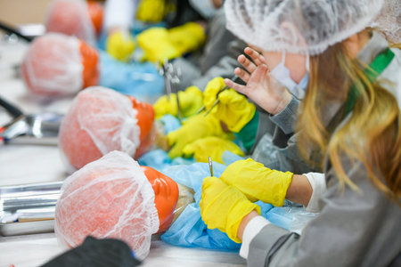 Young girl doctor. Interest in medicine in children. Children in medical coats. Medical training. KHARKOV, UKRAINE - JANUARY 20, 2020.のeditorial素材