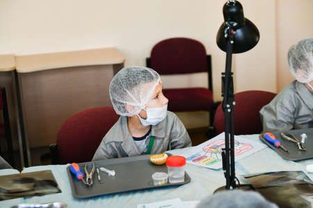Children at the lecture at the dentist. Training class in dentistry. children and a dentist. Teaching Dentistry. Training at the dentist. KHARKOV, UKRAINE - JANUARY 20, 2020.のeditorial素材