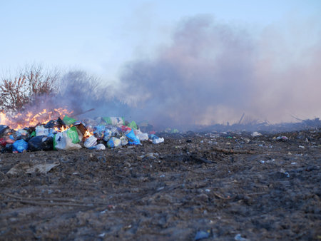 man burns a mountain of garbage/の写真素材