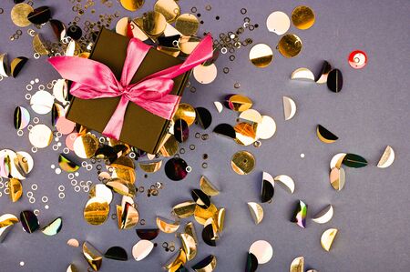 Gift black box with bow on multicolor background. Flat lay composition for birthday or wedding. 1 year conceptの写真素材
