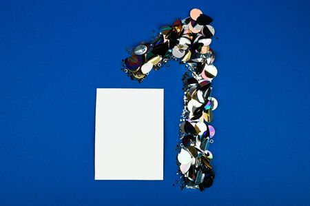 1 year anniversary celebration with elegant celebration. Blank card with glitter number 1 on dark blue background. Flat lay.の写真素材