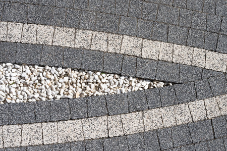 decorative gray tiles laid out on a flat surface.